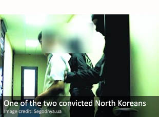 One of the two North Koreans being led to court